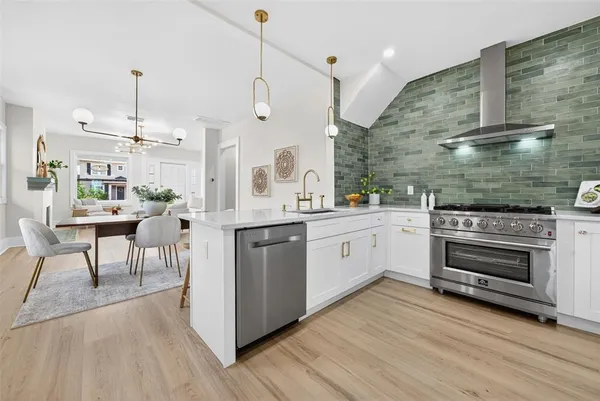 a kitchen with a stove a sink and a refrigerator