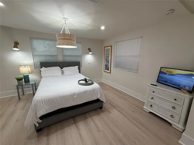 a bedroom with a bed and a lamp