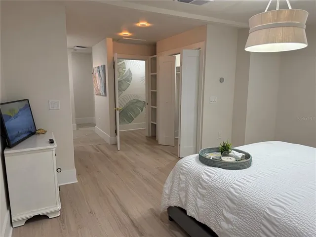 a bedroom with a bed and a chair