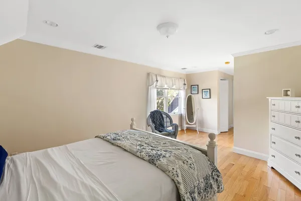 a bedroom with a bed and a dresser in it