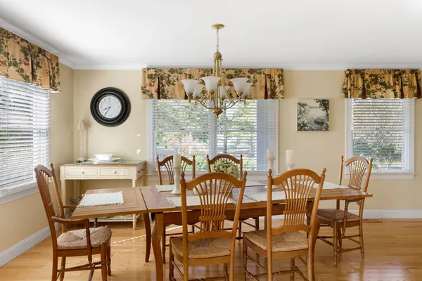 a view of a dining room with furniture and wooden floor