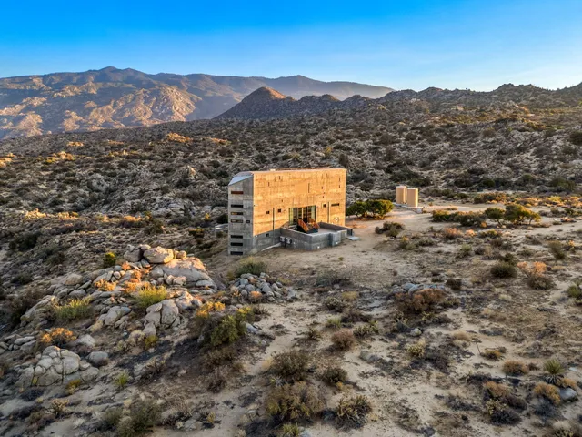 a view of a lush green hillside and houses