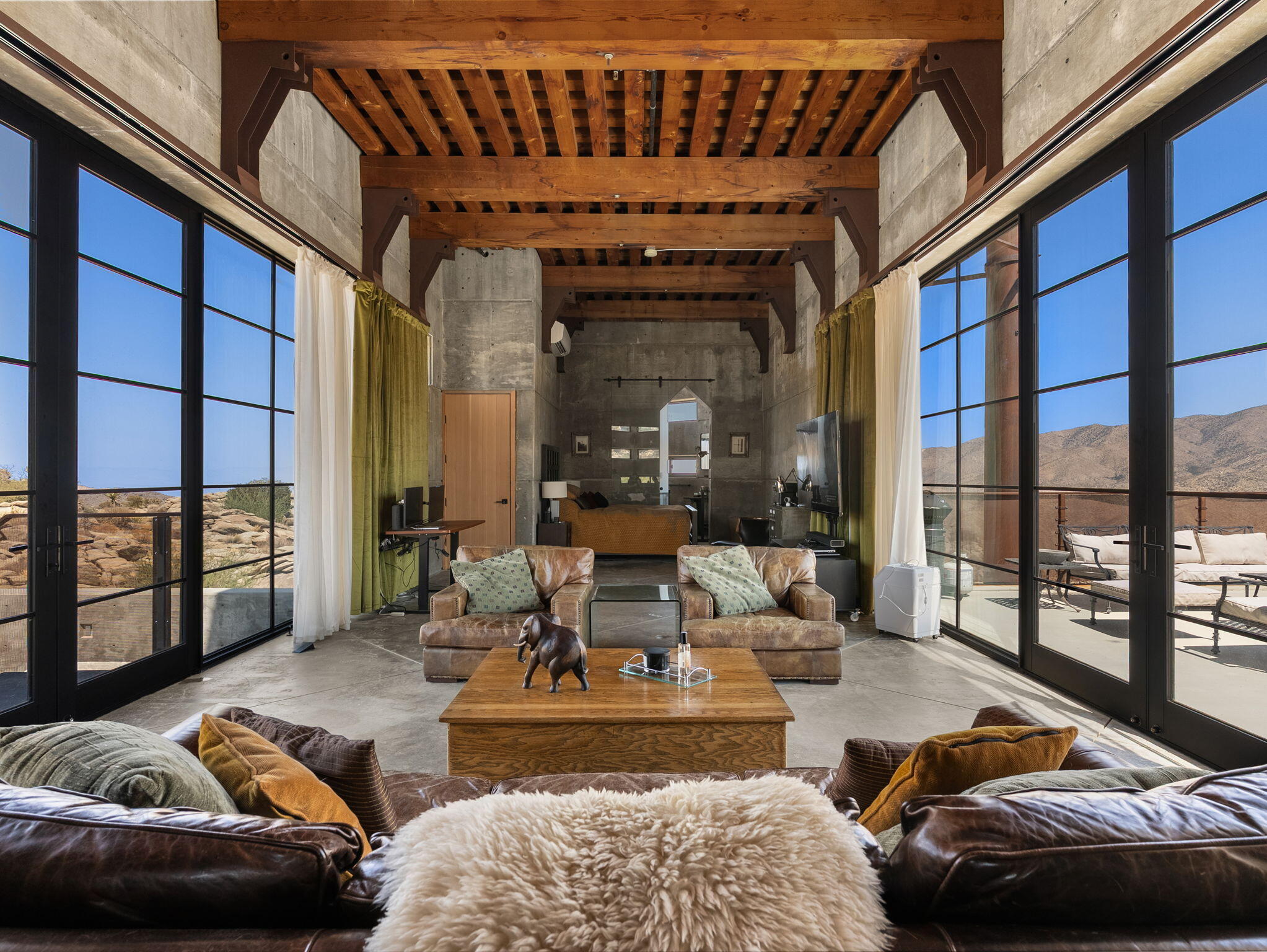 60240 Juniper Road Mountain Center, CA 92561 - Photo 20 of 37 a living room with furniture and a floor to ceiling window