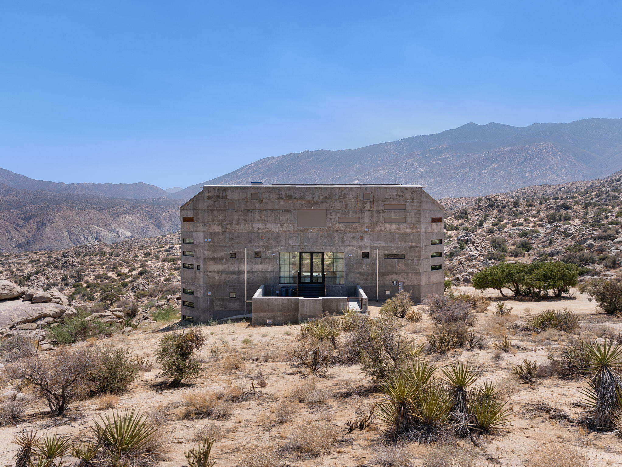60240 Juniper Road Mountain Center, CA 92561 - Photo 2 of 37 a view of a large building in the middle of a yard
