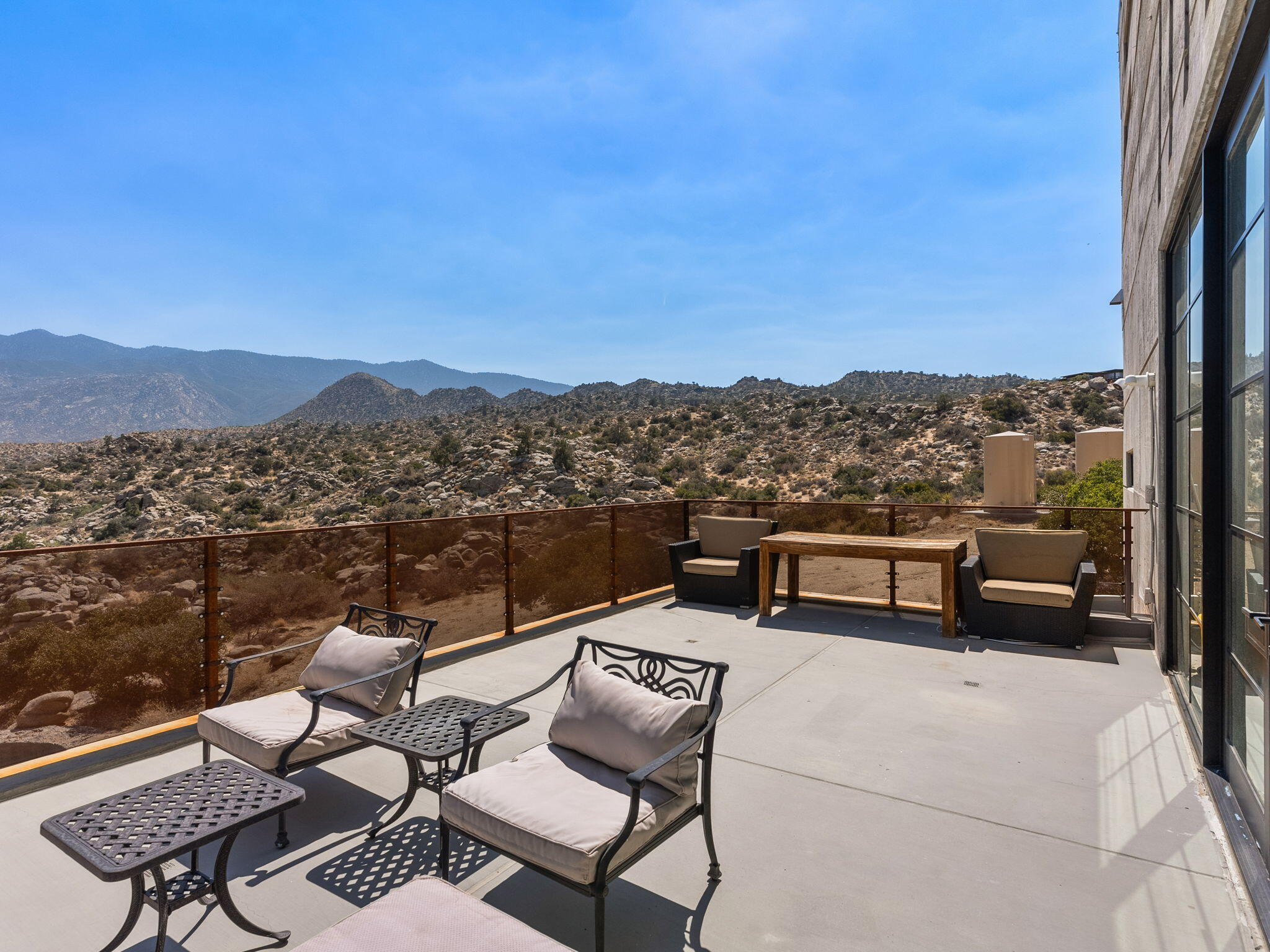 60240 Juniper Road Mountain Center, CA 92561 - Photo 22 of 37 a view of a terrace with couches and a table