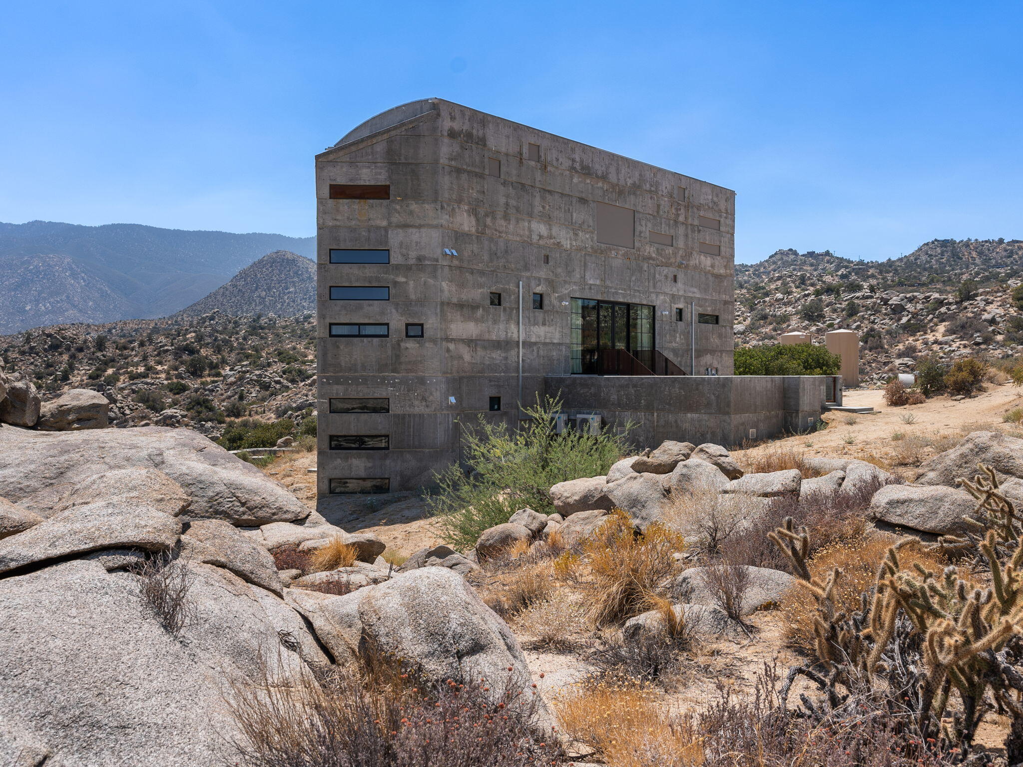 60240 Juniper Road Mountain Center, CA 92561 - Photo 3 of 37 a tall building with a large tree in the background