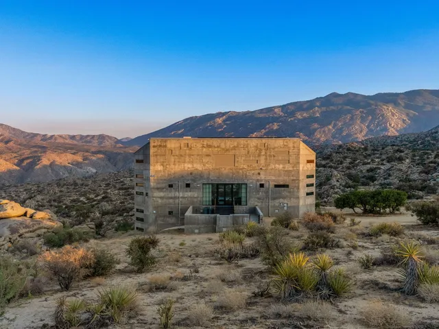 a view of a large building with a mountain in the background