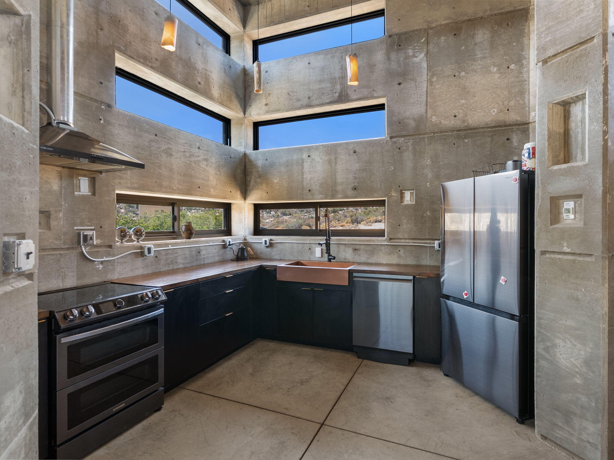 60240 Juniper Road Mountain Center, CA 92561 - Photo 9 of 37 a kitchen with stainless steel appliances granite countertop a stove and a refrigerator