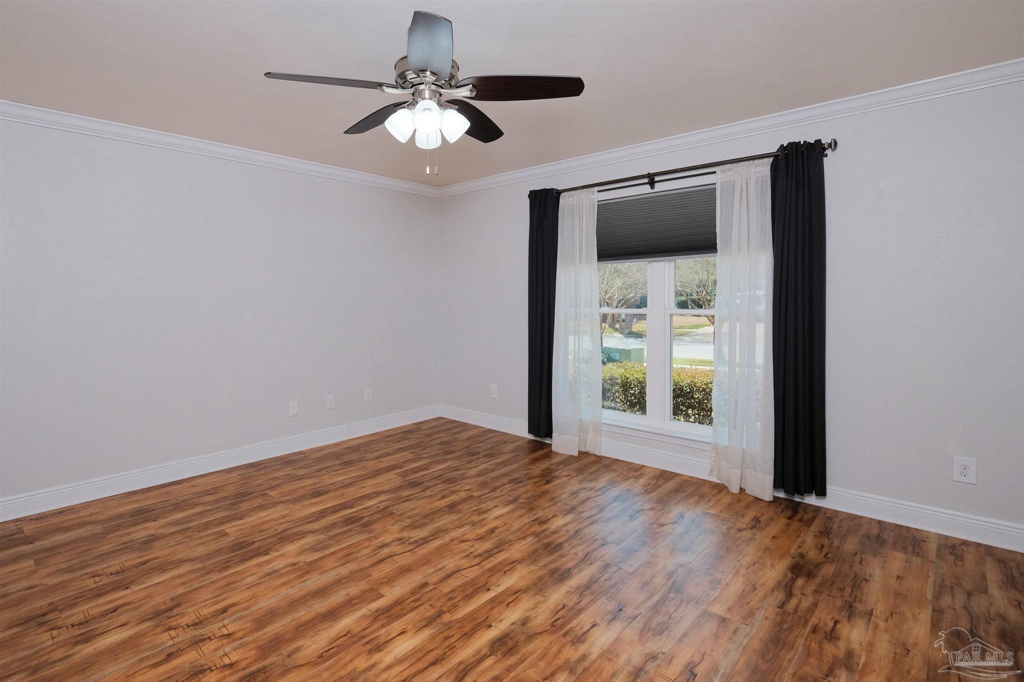 1908 Joshua Drive Cantonment, FL 32533 - Photo 24 of 47 a view of an empty room with wooden floor and a window