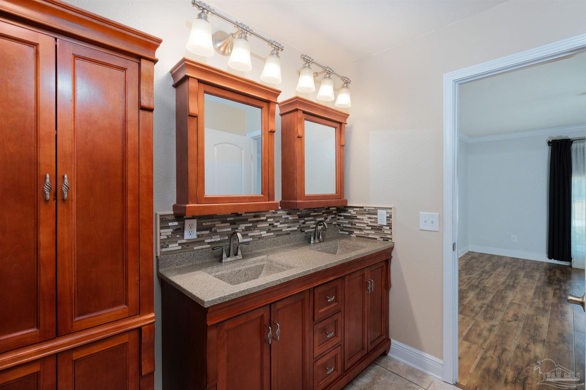 1908 Joshua Drive Cantonment, FL 32533 - Photo 30 of 47 a bathroom with a sink and a mirror