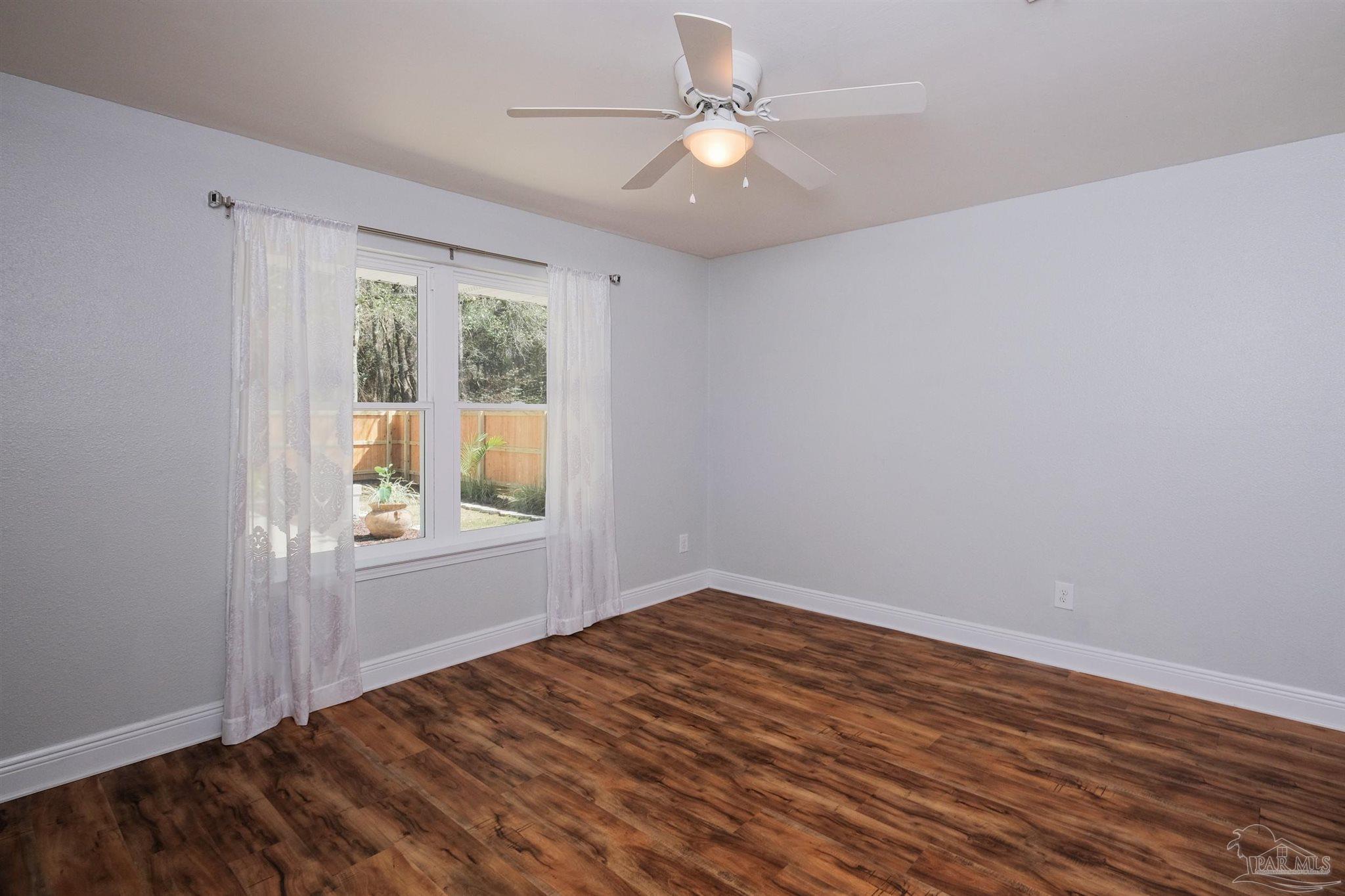 1908 Joshua Drive Cantonment, FL 32533 - Photo 37 of 47 wooden floor in an empty room with a window