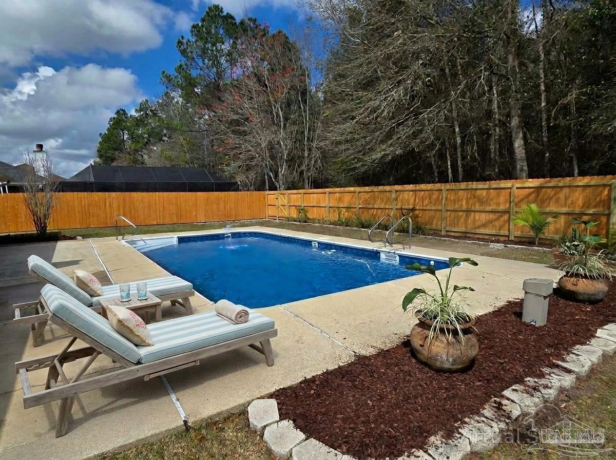 1908 Joshua Drive Cantonment, FL 32533 - Photo 40 of 47 a view of a swimming pool with some potted plants