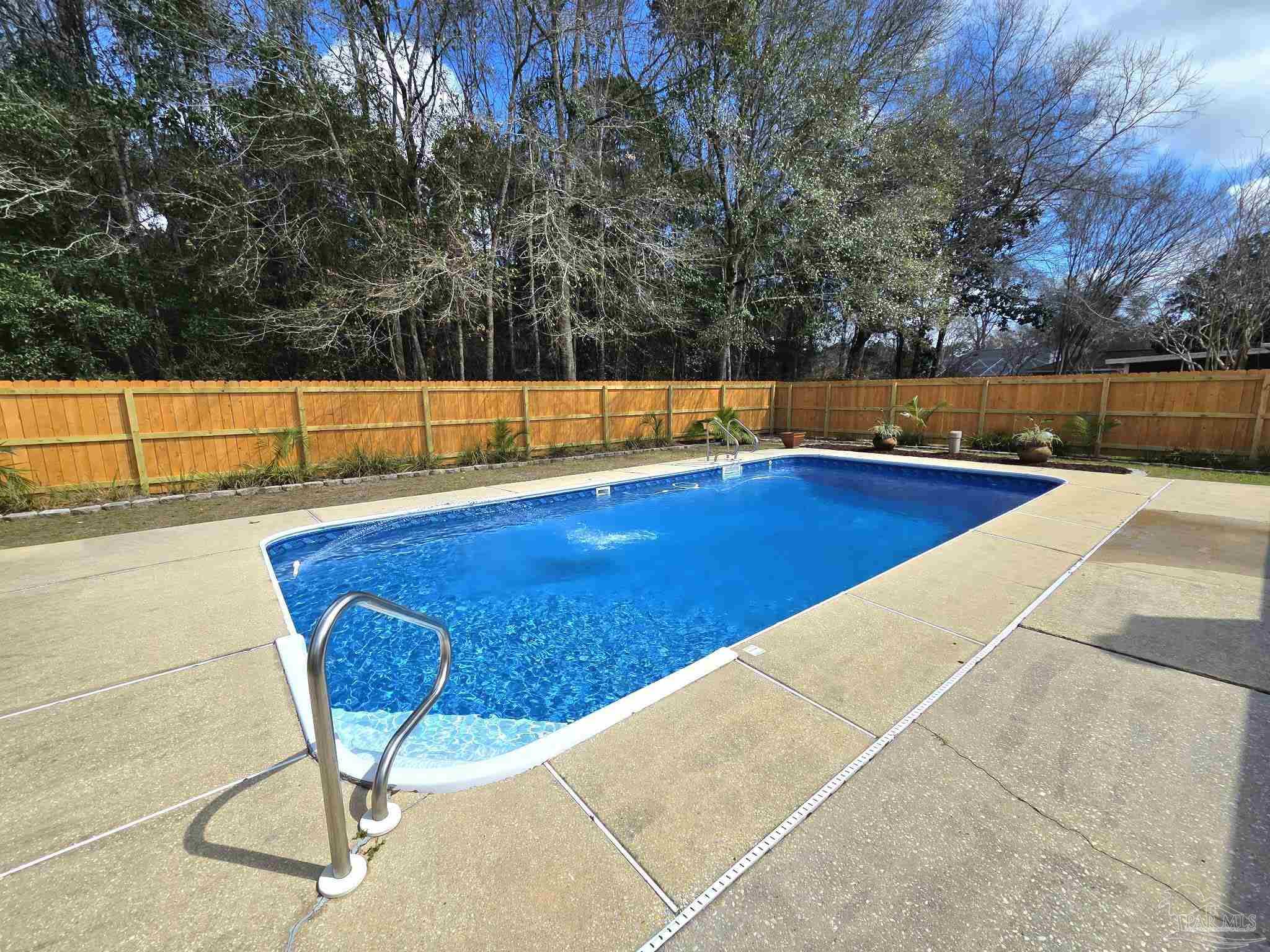 1908 Joshua Drive Cantonment, FL 32533 - Photo 4 of 47 a view of a swimming pool with an outdoor seating and yard