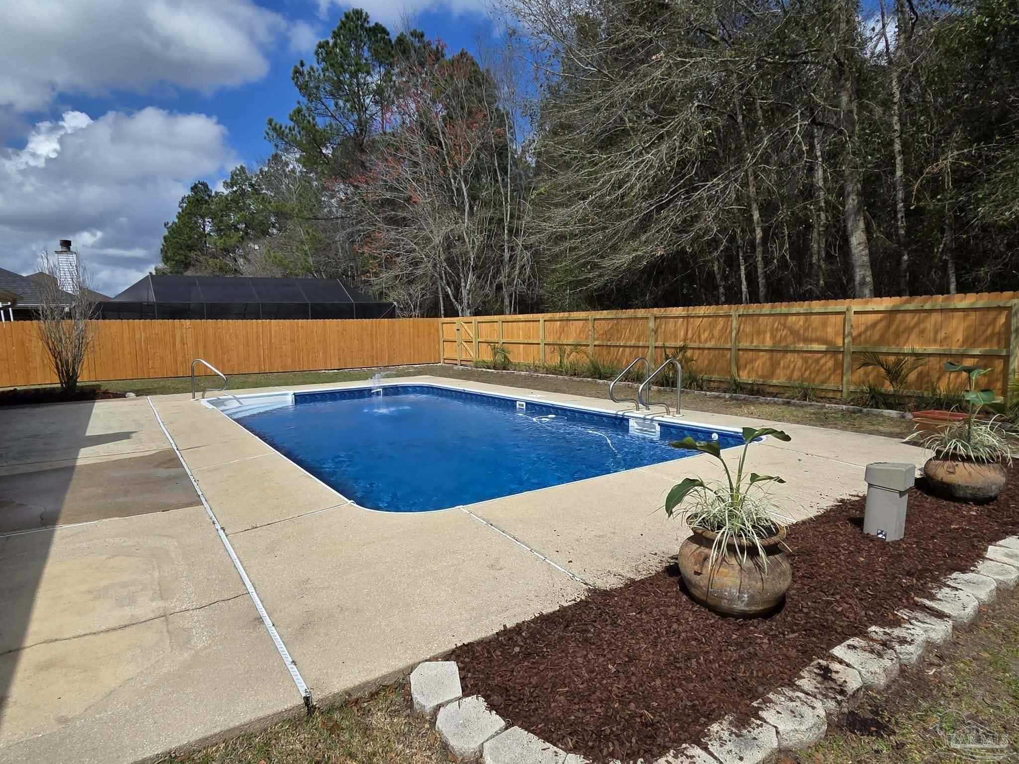 1908 Joshua Drive Cantonment, FL 32533 - Photo 41 of 47 a view of a swimming pool with potted plants