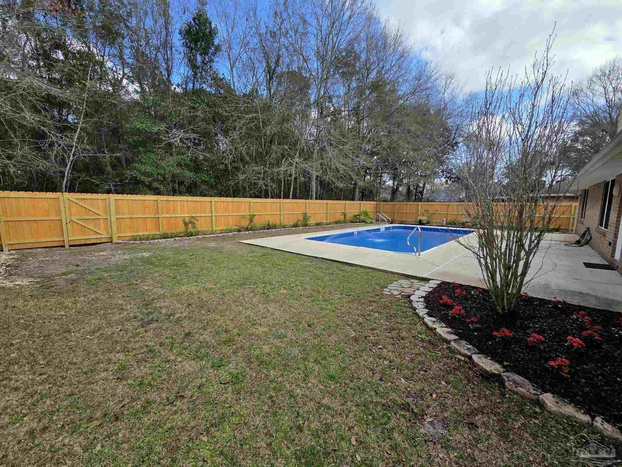 1908 Joshua Drive Cantonment, FL 32533 - Photo 43 of 47 a view of a backyard with swimming pool
