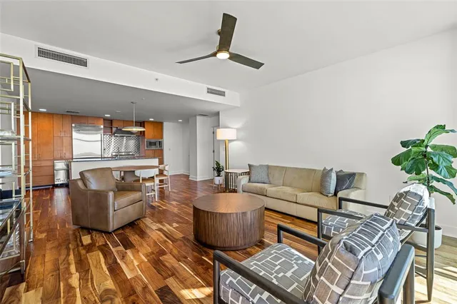 a living room with furniture and a wooden floor