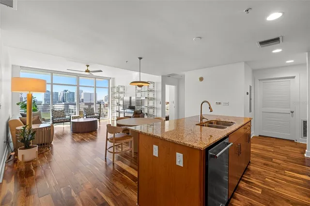 a kitchen with kitchen island granite countertop lots of counter top space and living room