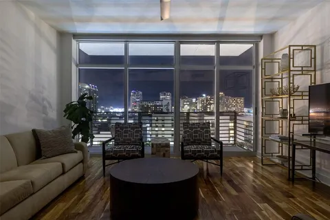 a dining room with furniture and wooden floor