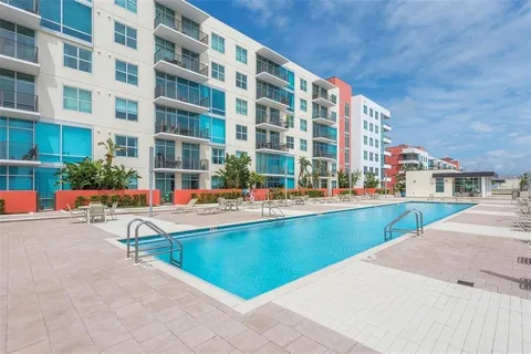 a swimming pool with outdoor seating and yard