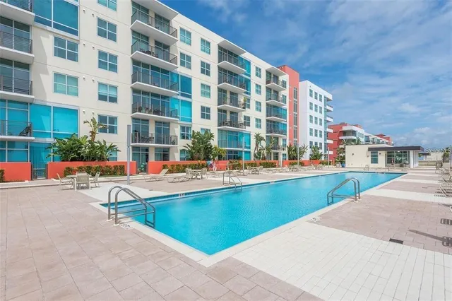 a swimming pool with outdoor seating and yard