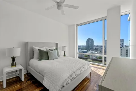 a bedroom with a bed and a dresser with mirror