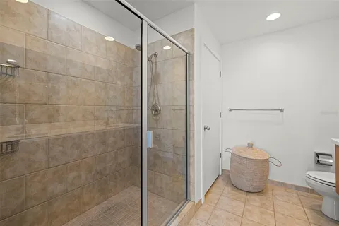 a bathroom with a toilet and a shower