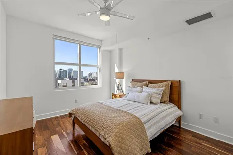 a bedroom with a bed and wooden floor