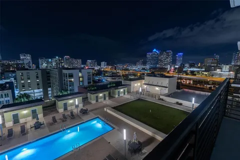 a kitchen with stainless steel appliances granite countertop a stove a sink dishwasher and cabinets with wooden floor