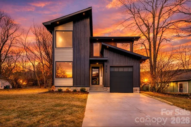 a view of a house with a yard covered with snow
