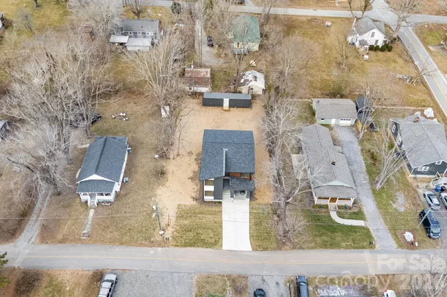 an aerial view of a house with a yard