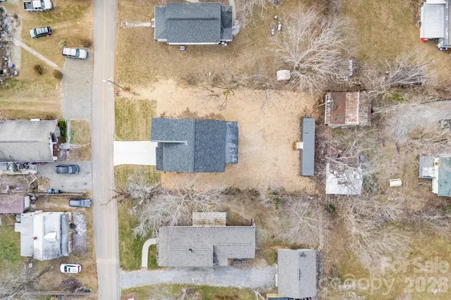 an aerial view of residential house with parking