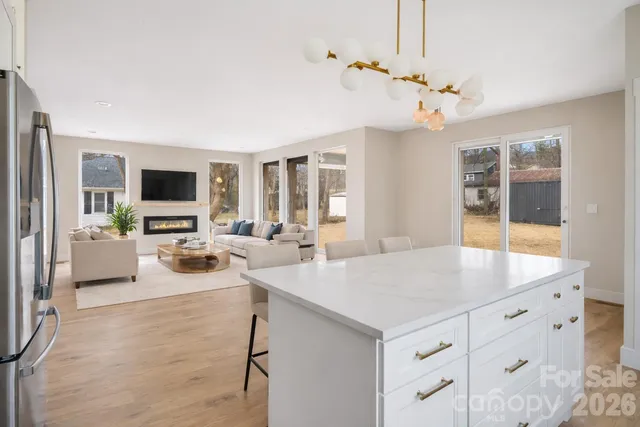 a view of a dining room with furniture and a chandelier