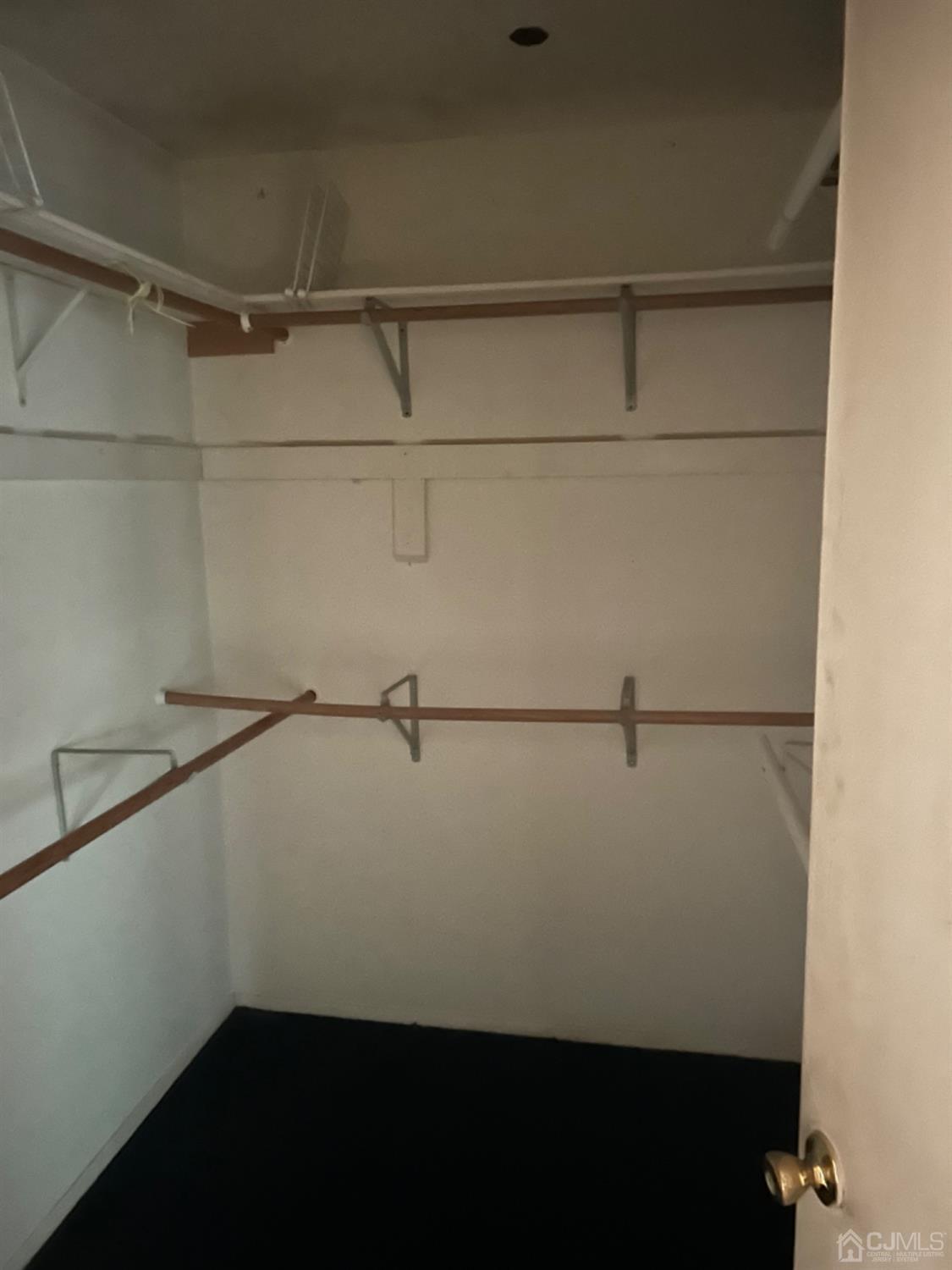 6 Woodbury Road Edison, NJ 08820 - Photo 16 of 18 a view of a room with racks on the wall