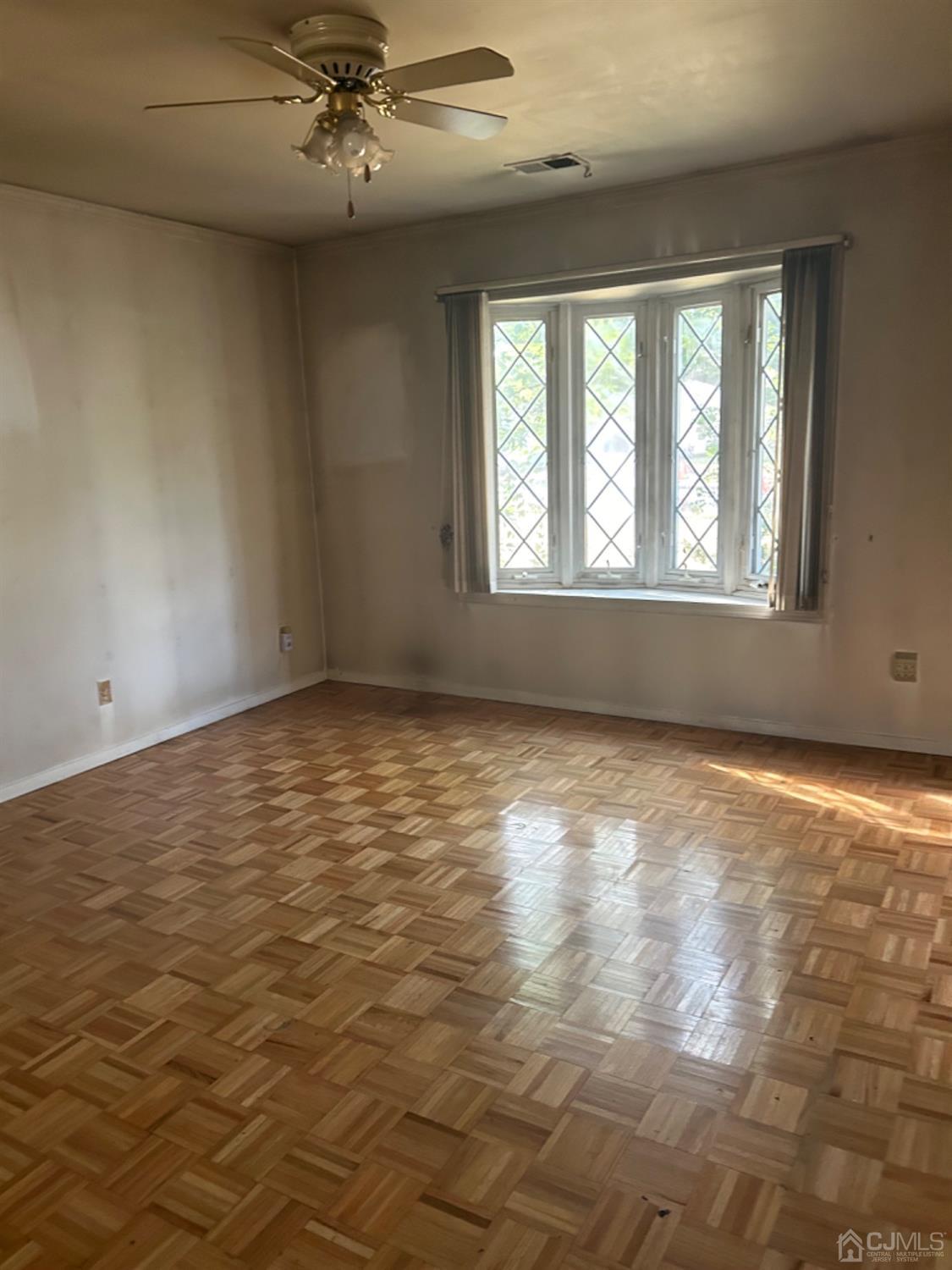 6 Woodbury Road Edison, NJ 08820 - Photo 4 of 18 an empty room with a empty space and windows