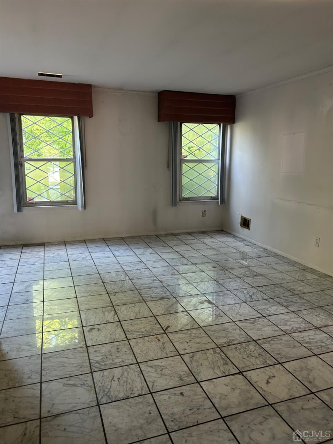 6 Woodbury Road Edison, NJ 08820 - Photo 8 of 18 an empty room with windows