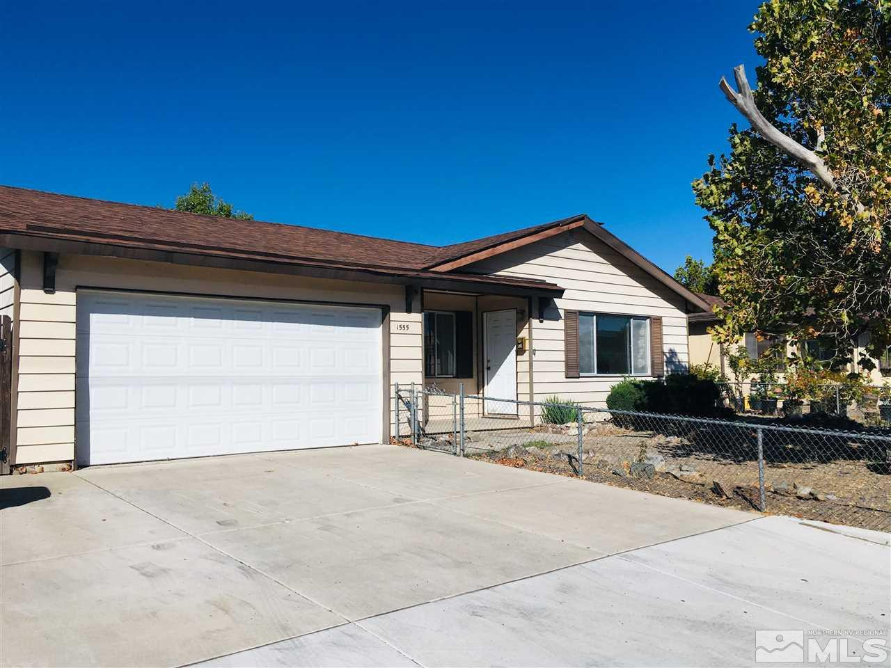 1555 Harvard Way Reno, NV 89502 - Photo 1 of 1 a front view of a house with a garage