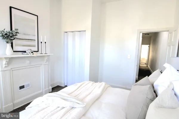 a bedroom with a bed and a mirror