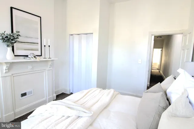 a bedroom with a bed and a mirror