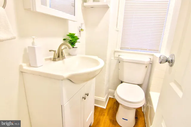 a white toilet sitting next to a bathroom sink
