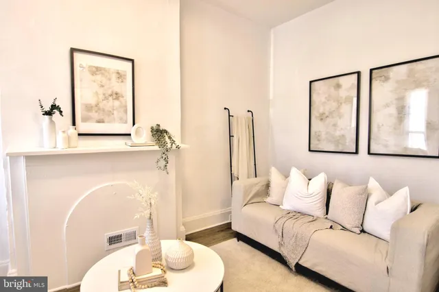 a living room with furniture and a painting