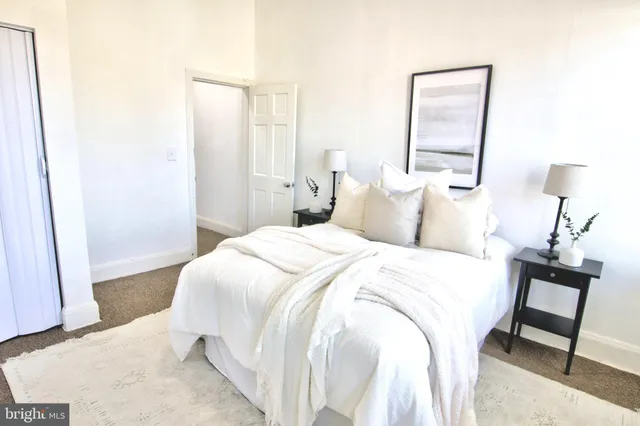 a bedroom with a bed and a mirror