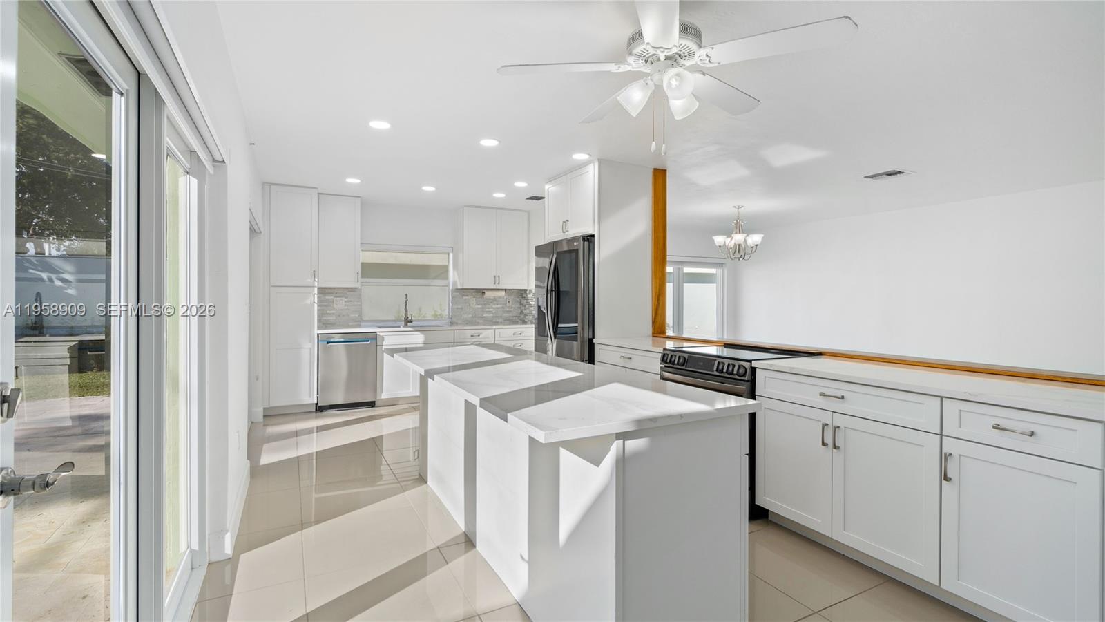 8614 Southwest 102nd Place Miami, FL 33173 - Photo 11 of 44 a kitchen with white cabinets and white appliances