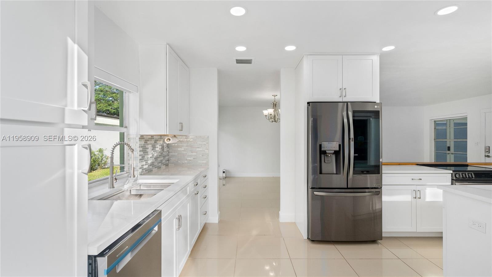 8614 Southwest 102nd Place Miami, FL 33173 - Photo 13 of 44 a kitchen with a sink appliances and cabinets