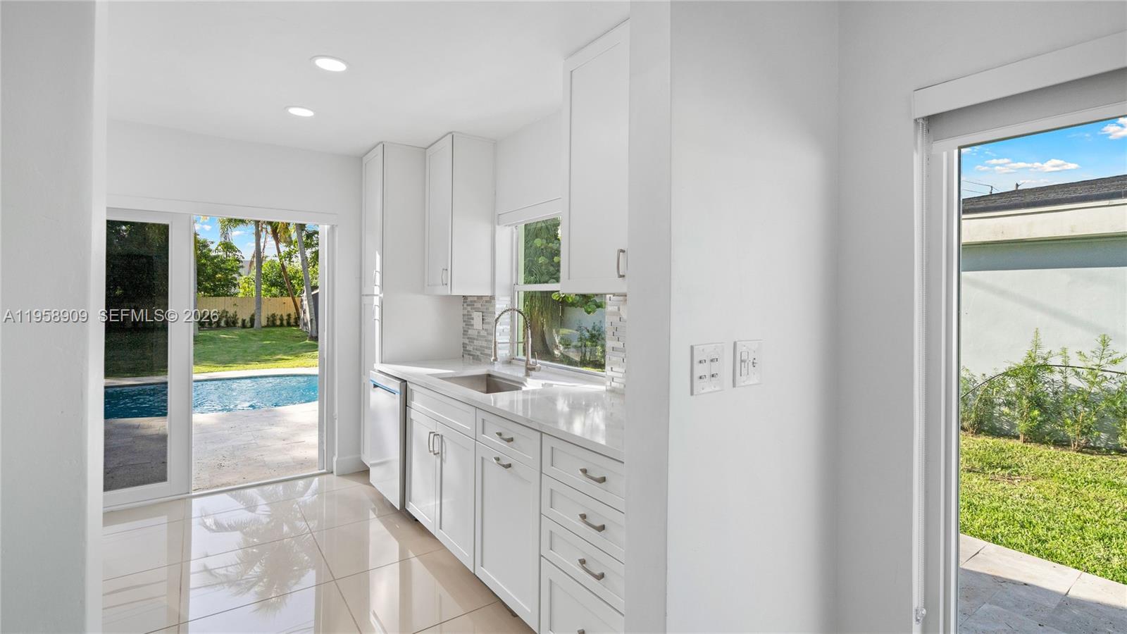 8614 Southwest 102nd Place Miami, FL 33173 - Photo 16 of 47 a bathroom with a double vanity sink and a large mirror
