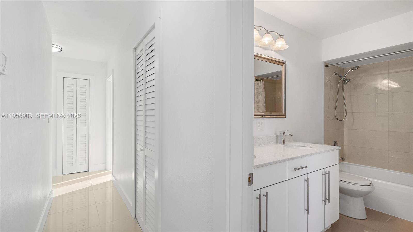 8614 Southwest 102nd Place Miami, FL 33173 - Photo 17 of 44 a bathroom with a toilet a sink and a mirror