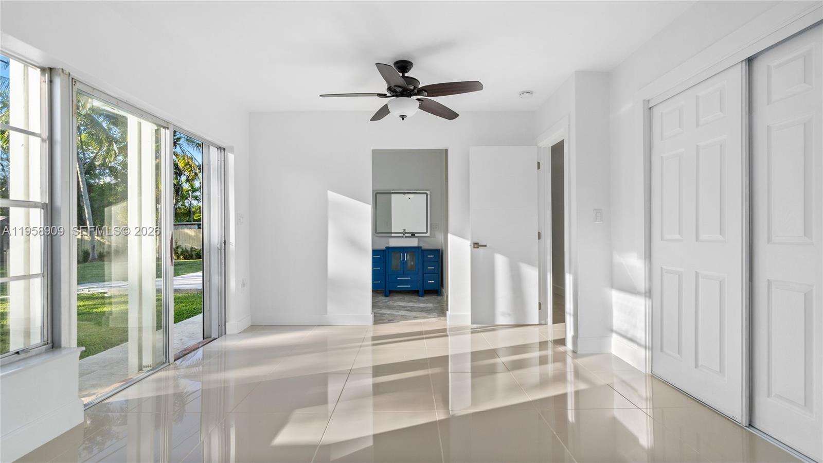 8614 Southwest 102nd Place Miami, FL 33173 - Photo 25 of 44 wooden floor in an empty room with a window