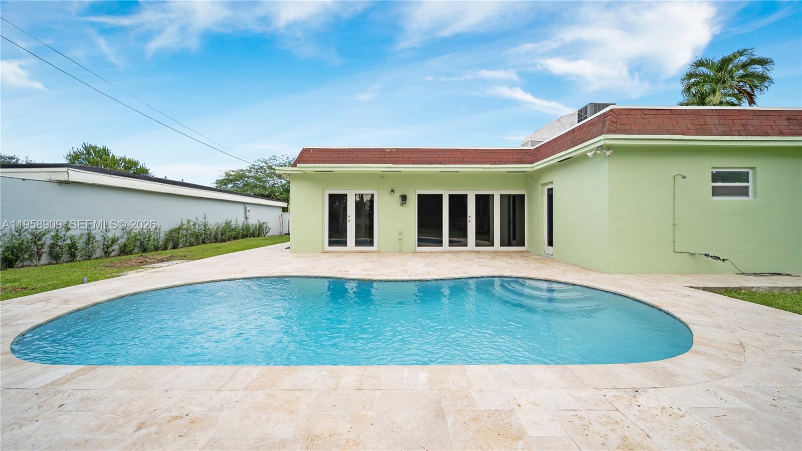 8614 Southwest 102nd Place Miami, FL 33173 - Photo 29 of 44 a view of a house with a swimming pool