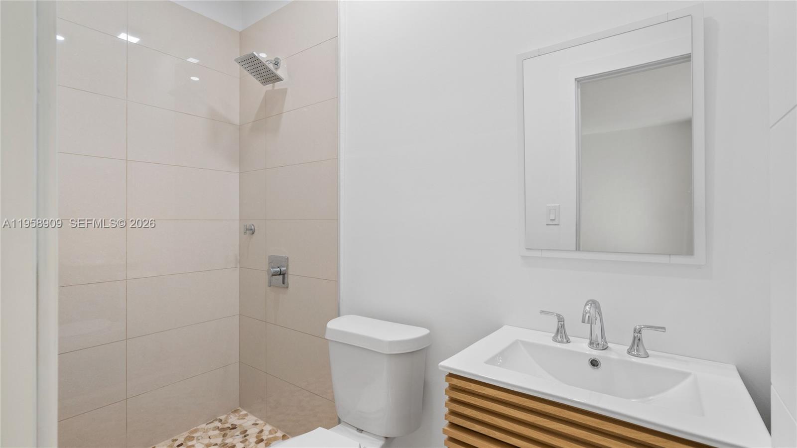 8614 Southwest 102nd Place Miami, FL 33173 - Photo 43 of 44 a bathroom with a sink a toilet and shower