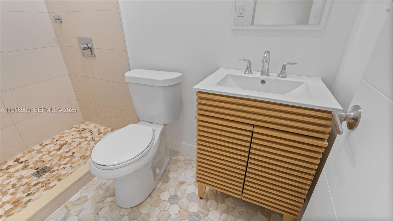 8614 Southwest 102nd Place Miami, FL 33173 - Photo 46 of 47 a bathroom with a sink and a toilet