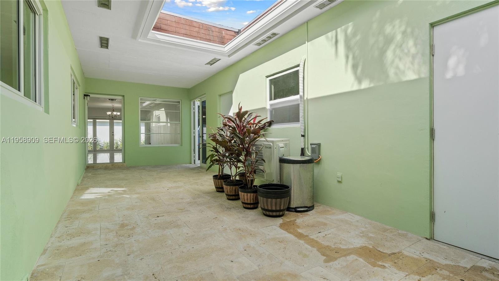 8614 Southwest 102nd Place Miami, FL 33173 - Photo 5 of 47 a view of a hallway with a livingroom and furniture